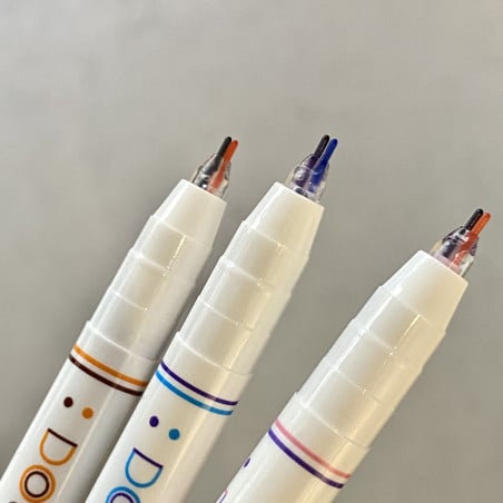 pink and purple, orange and brown and light blue and cobalt blue nibs of the three felt pens